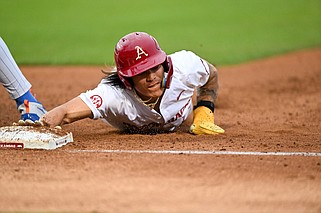 Arkansas' Wehiwa Aloy slides back to first base in the fourth inning of a baseball game at Baum-Walker Stadium in Fayetteville in this April 26, 2024, file photo. (NWA Democrat Gazette/Caleb Grieger)